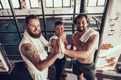 Premium Photo Resting Athletes Giving High Five To Each Other