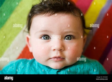 Beautiful Baby Girl with brown hair and blue eyes Stock Photo - Alamy