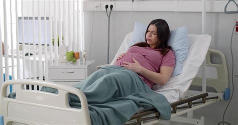 Premium Photo Pregnant Woman Lying In Patient Bed Having Stomach Aches