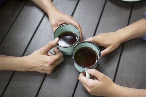 Two People Seated At A Table Drinking Coffee Viewed From Above Stock