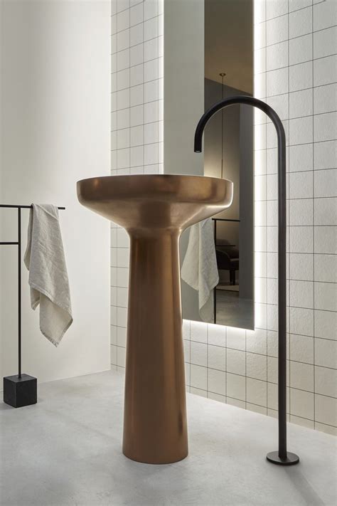 A Bathroom With A Sink Mirror And Towel Rack On The Wall Next To It