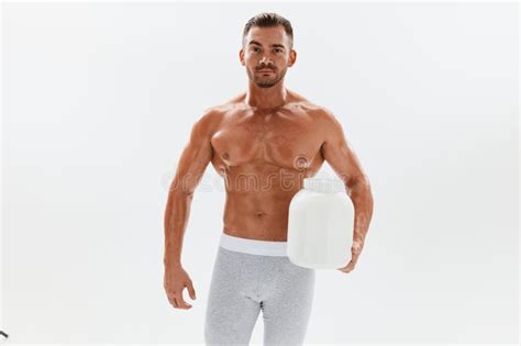 Man Bodybuilder Boxer With Naked Torso With Abs Holding A Can Of Muscle