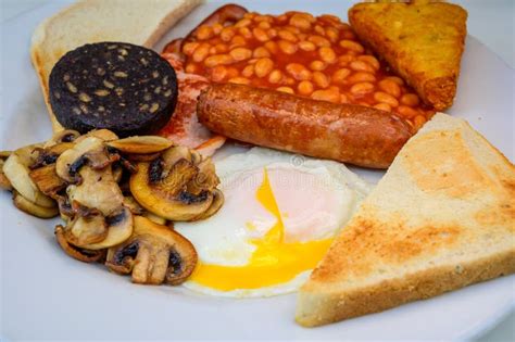 White Board With Full English Breakfast With Bacon Fried Egg Beans Tomato Roasted Sausage