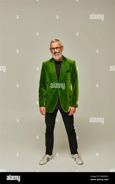 Cheerful Good Looking Mature Man With Beard And Glasses In Green Blazer