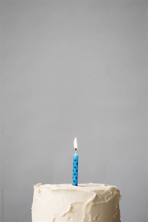 "Birthday Cake With Blue Candle" by Stocksy Contributor "Ruth Black ...