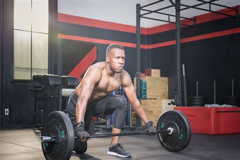Muscular Man Working Out In Gym Doing Exercises With Barbell Strong Male Naked Torso Abs Stock