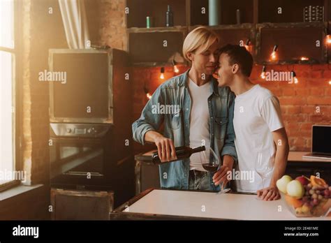 Loving Gay Couple At Home Two Handsome Men Hugging And Kissing On Kitchen Romantic Atmosphere