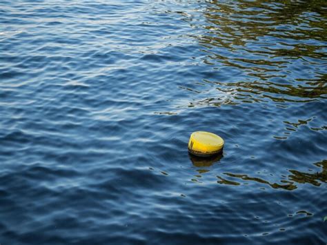 Premium Photo High Angle View Of Yellow Buoy Floating On Water