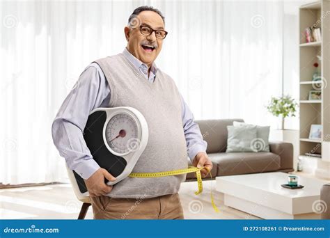 Corpulent Mature Man Holding A Weight Scale And A Measuring Tape In A