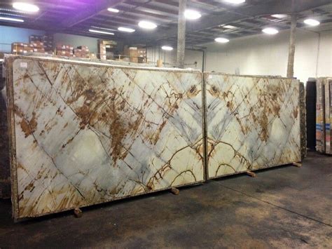 Two Large Marble Slabs Sitting On Pallets In A Room With Other Items