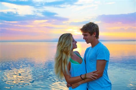 Premium Photo | Blond young couple hug in sunset sea lake happy