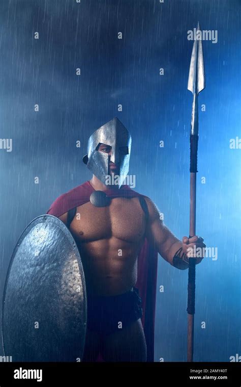 Portrait Of Spartan Warrior Standing Outdoors With Spear And Shield In