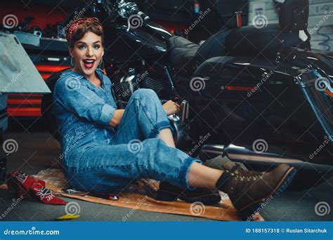 Beautiful Girl Posing Repairs A Motorcycle In A Workshop Pin Up Style