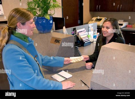 Customer Depositing Cash At A Teller Window Stock Photo Alamy