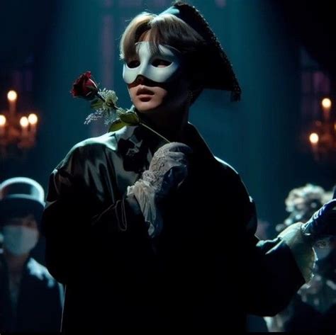 A Person With A Mask Holding A Rose In Front Of A Group Of People