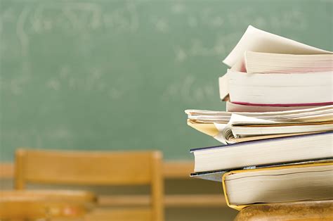 Pile Of Books On A Desk In A Classroom Public Policy Institute Of