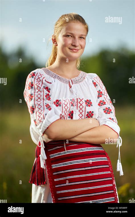 Portrait Of A Romanian Girl In Traditional Costume In An Oak Forest