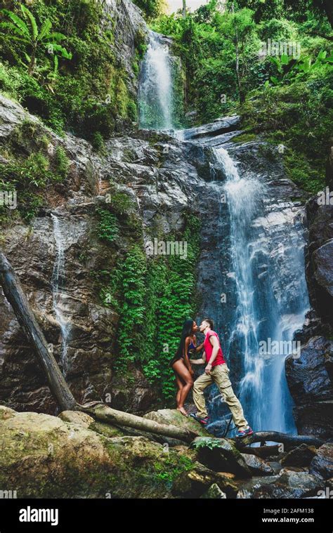 Couple Hugging And Kissing Under Waterfalls Stock Photo Alamy