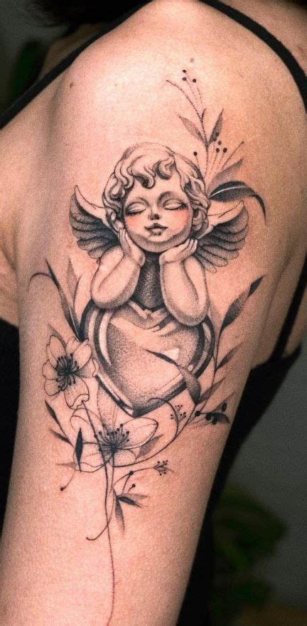 An Angel Tattoo On The Back Of A Woman S Upper Half Sleeved Arm