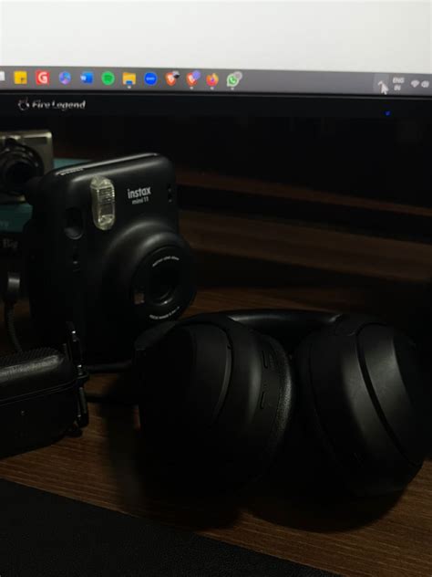 An Image Of A Computer Screen With Headphones And Camera On The Desk