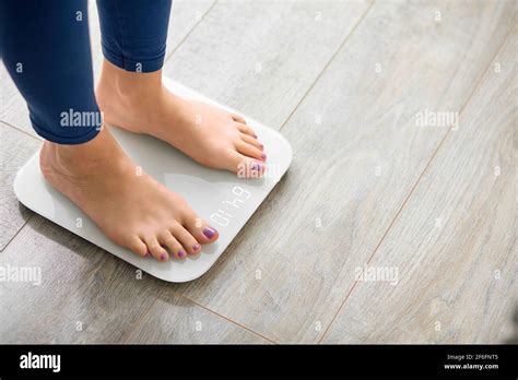 Close Up Photo Of Woman Legs Stepping On Floor Scales Indoors Space