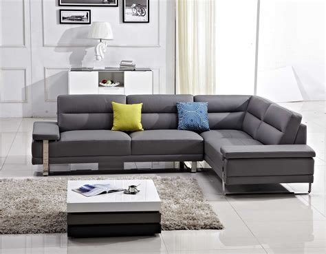 A Modern Living Room With Grey Couches And White Rugs On The Floor In