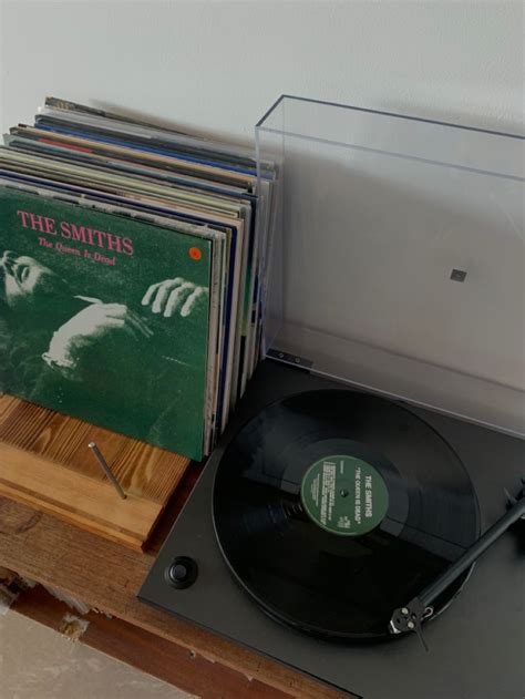 An Old Record Player And Some Records On A Table