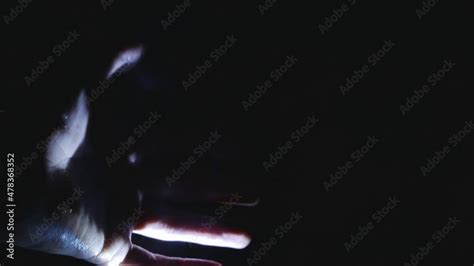 A Man Warms His Hands After Hypothermia While Sitting By A Warm Hearth