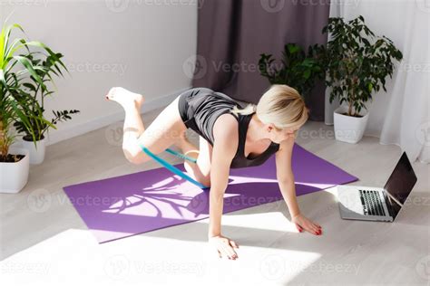 Fitness Woman Exercising On The Floor At Home And Watching Fitness