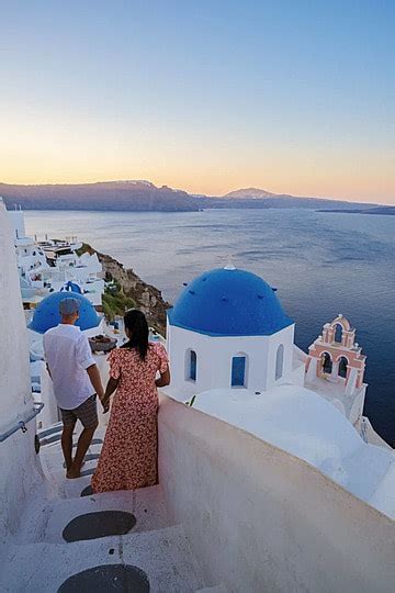 Vacationing Couple In Santorini And Oia Village Streets Photo