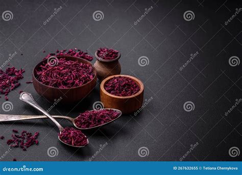 Dried Beets In Small Slices In A Wooden Bowl On A Black Concrete