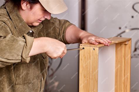 Premium Photo Handyman Is Assembling Drawer Of Flat Pack Furniture By