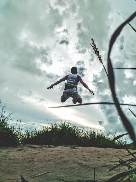 Premium Photo Man Jumping Against Sky