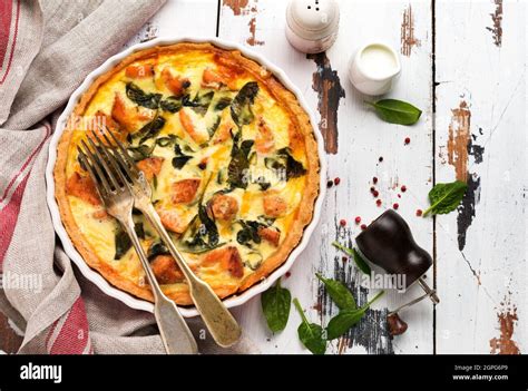 Homemade Quiche Tart With Red Fish And Spinach On Light Wooden