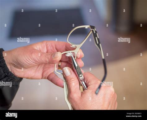Optician Preparing A Pair Of Glasses Adjustment Of The Nose Pads Stock