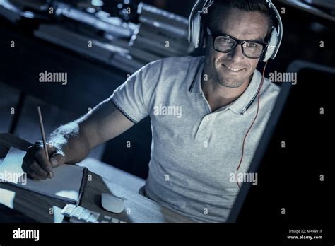 Cheerful Adult Gentleman Listening To Music While Working On Computer