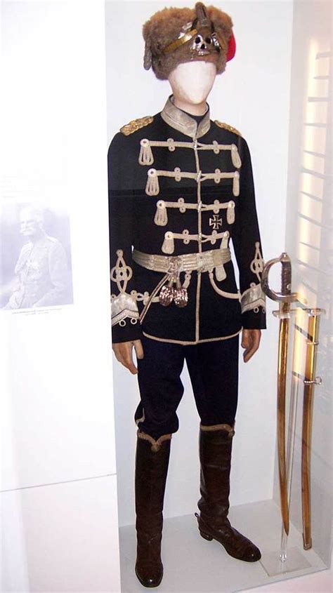 a uniform is displayed on display in a room with white walls and flooring,