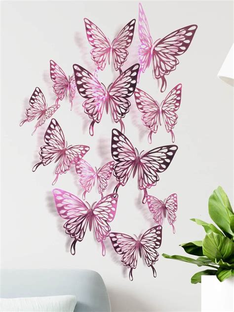 A Bunch Of Pink Butterflies Flying In The Air On A White Wall Next To A Plant