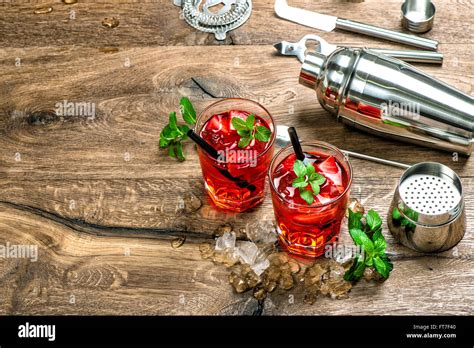 Red Cocktail With Ice Mint Leaves And Strawberry Campari Aperol