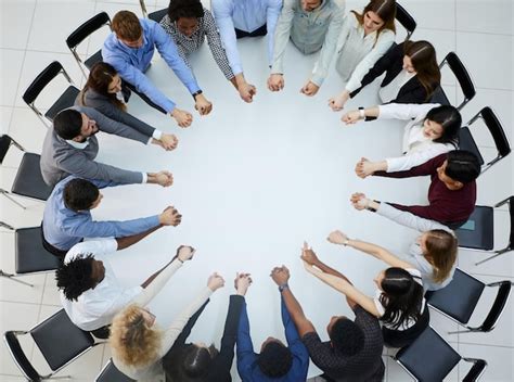 Premium Photo A Large Group Of People Sitting At A Round Table With