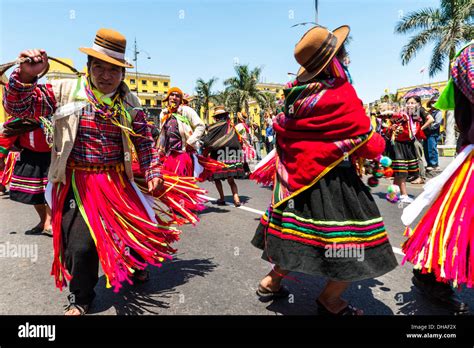 Indians In Traditional Peruvian Dresses Dancing In The Square Plaza