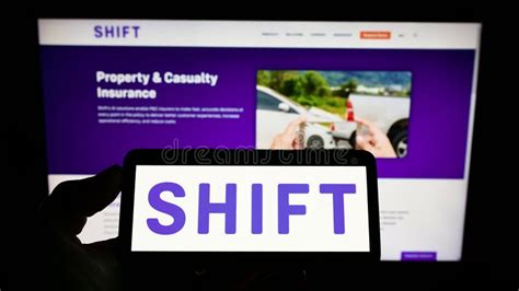 Person Holding Mobile Phone With Logo Of French Ai Company Shift