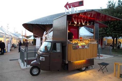 A Food Truck Is Parked On The Side Of The Road