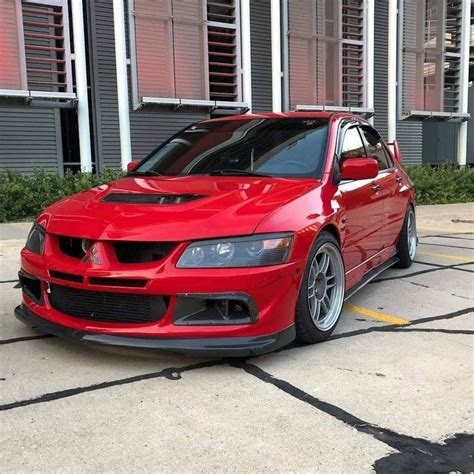 A Red Car Parked In Front Of A Building