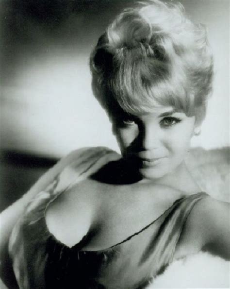 an old black and white photo of a woman with blonde hair wearing a fur coat