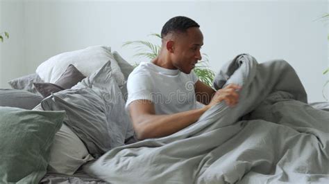 Black Man Waking Up In Morning Suddenly Happy Adult Sitting In Bed