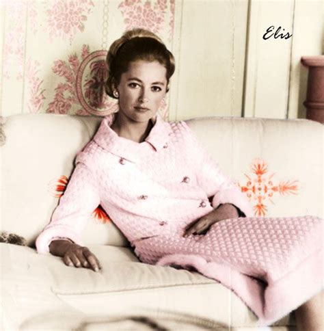 An Old Black And White Photo Of A Woman Sitting On A Couch