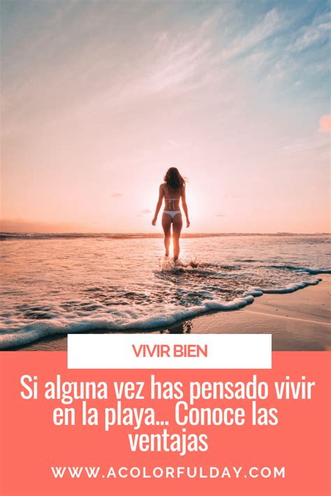 A Woman Standing In The Ocean At Sunset With Her Back To The Camera And