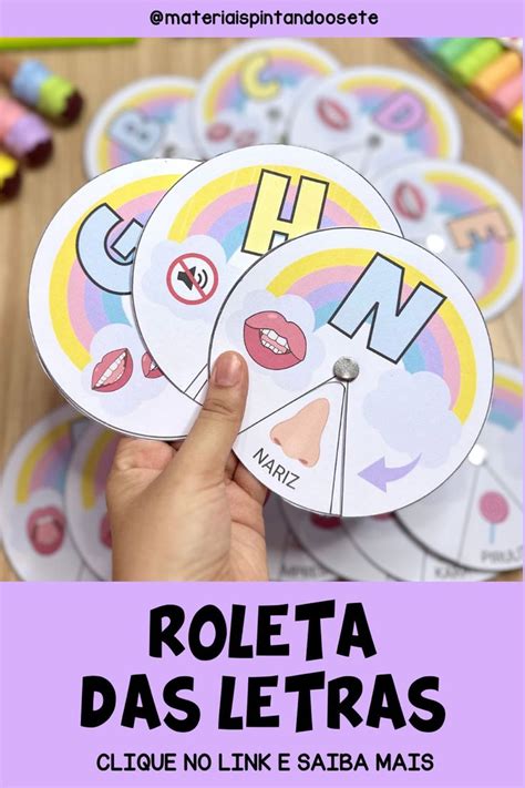 A Person Holding Up Some Stickers With The Words Roleta Dos Letras On Them