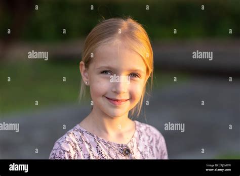 Candid Portrait Of Cute Little Caucasians Blue Eyed Girl With Blonde